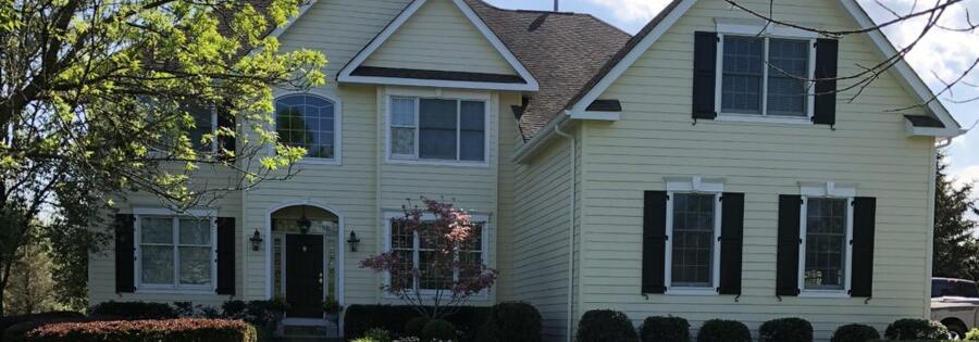 Painter cutting a clean line along trim on a New Jersey home