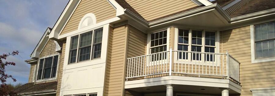 House siding being washed clean before an exterior repaint