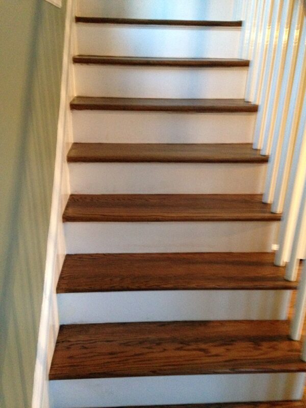 Hardwood stair treads sanded and stained with white risers